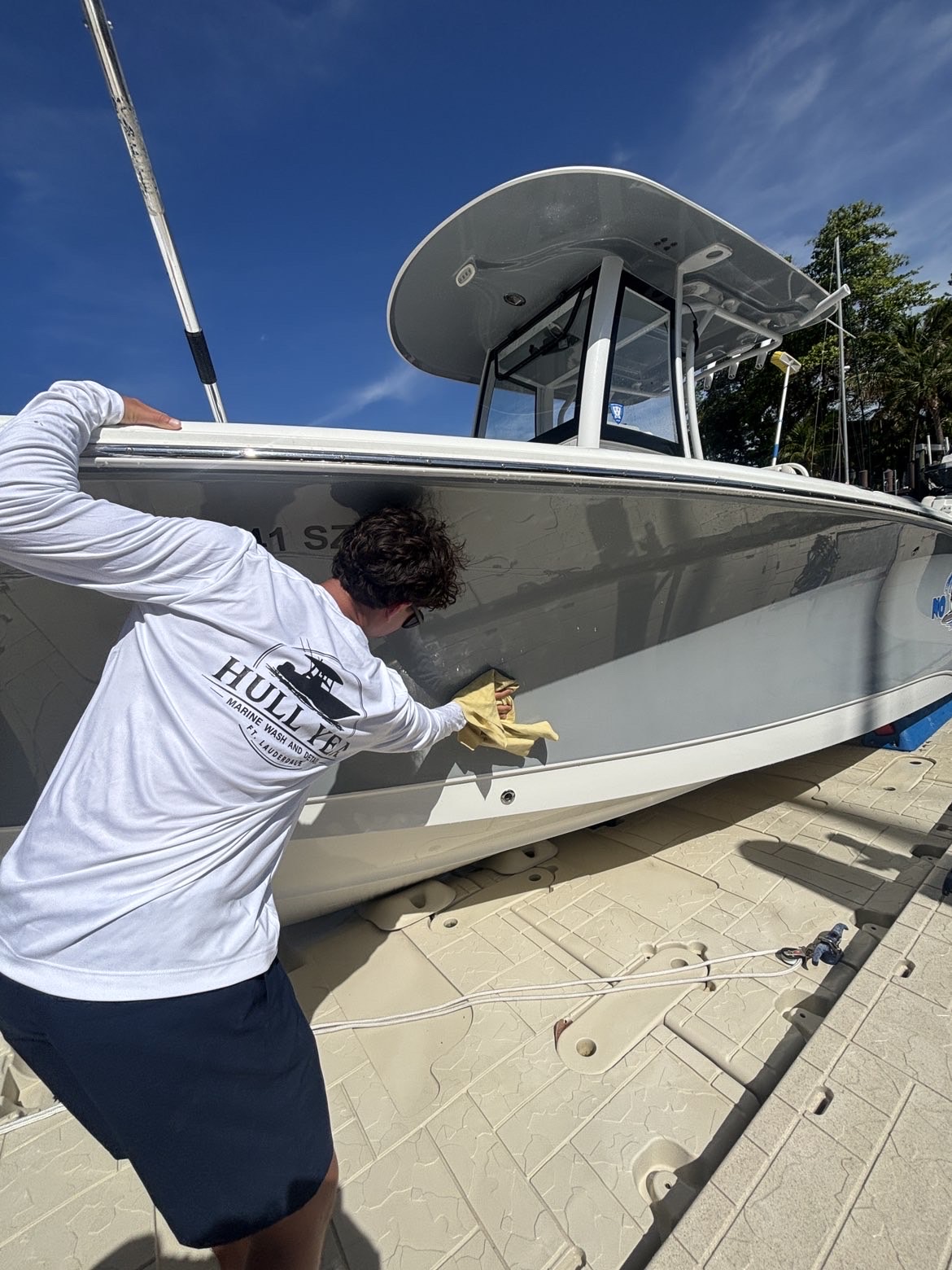 Hull Yea detailer polishing a boat hull